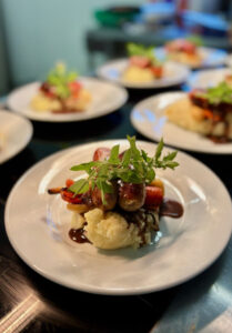 wedding catering pork belly on mash decorated with fresh rosemary